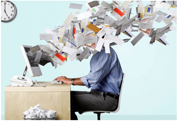 man sat in chair being bombarded with spam emails