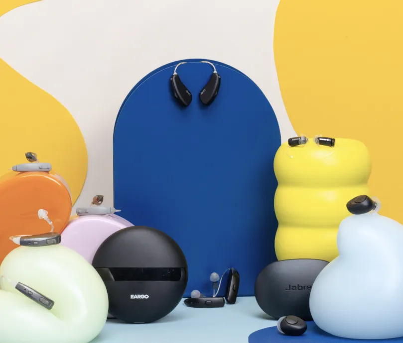 Hearing aids atop a variety of colorful sculptures.