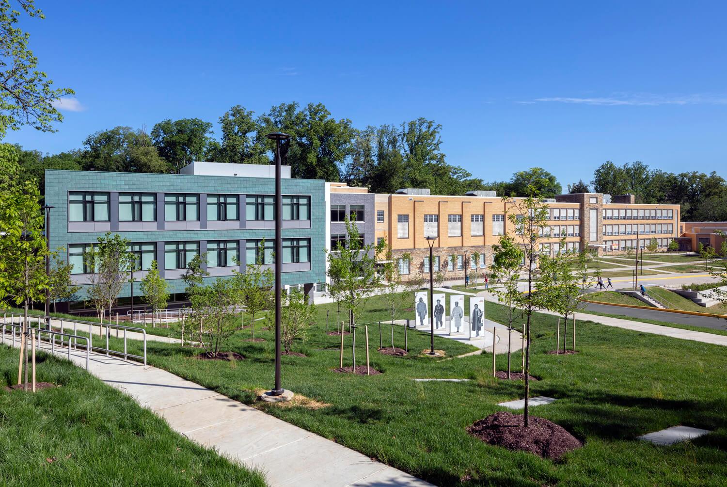 A photo of a historic school with a large modern addition.