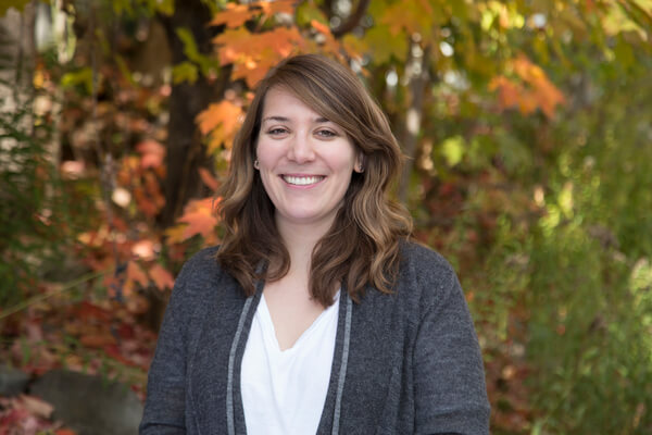 A photo of Stephanie Austin Redding in front of trees.