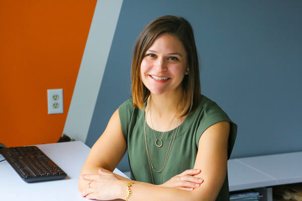 A photo of Karin Neubauer at her desk.
