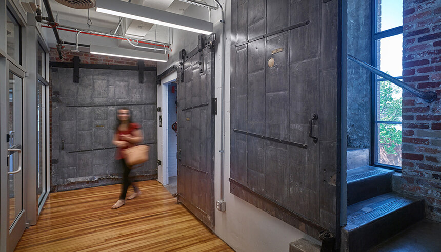 A photo in a hallway near historic fire doors.