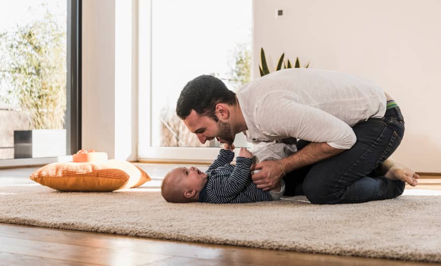 Man playing with child on floor