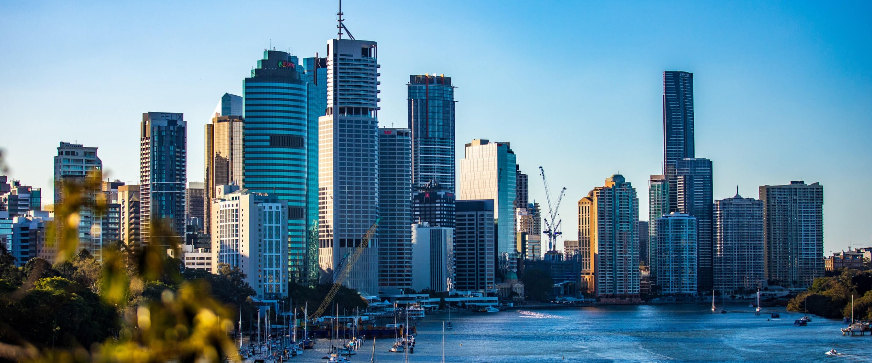 Sun rise on the Brisbane CBD, with high rise buildings along the Brisbane river front