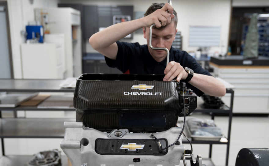 A man working on a Chevrolet engine