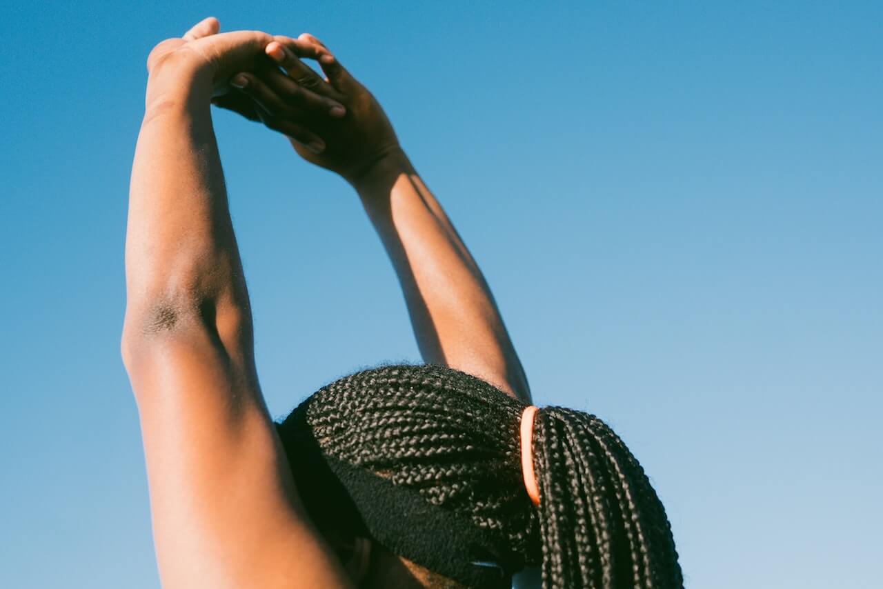 5 Tips to Start Your Fitness Journey with Limited Mobility, Injuries, or Disabilities - A women stretching her hands above head