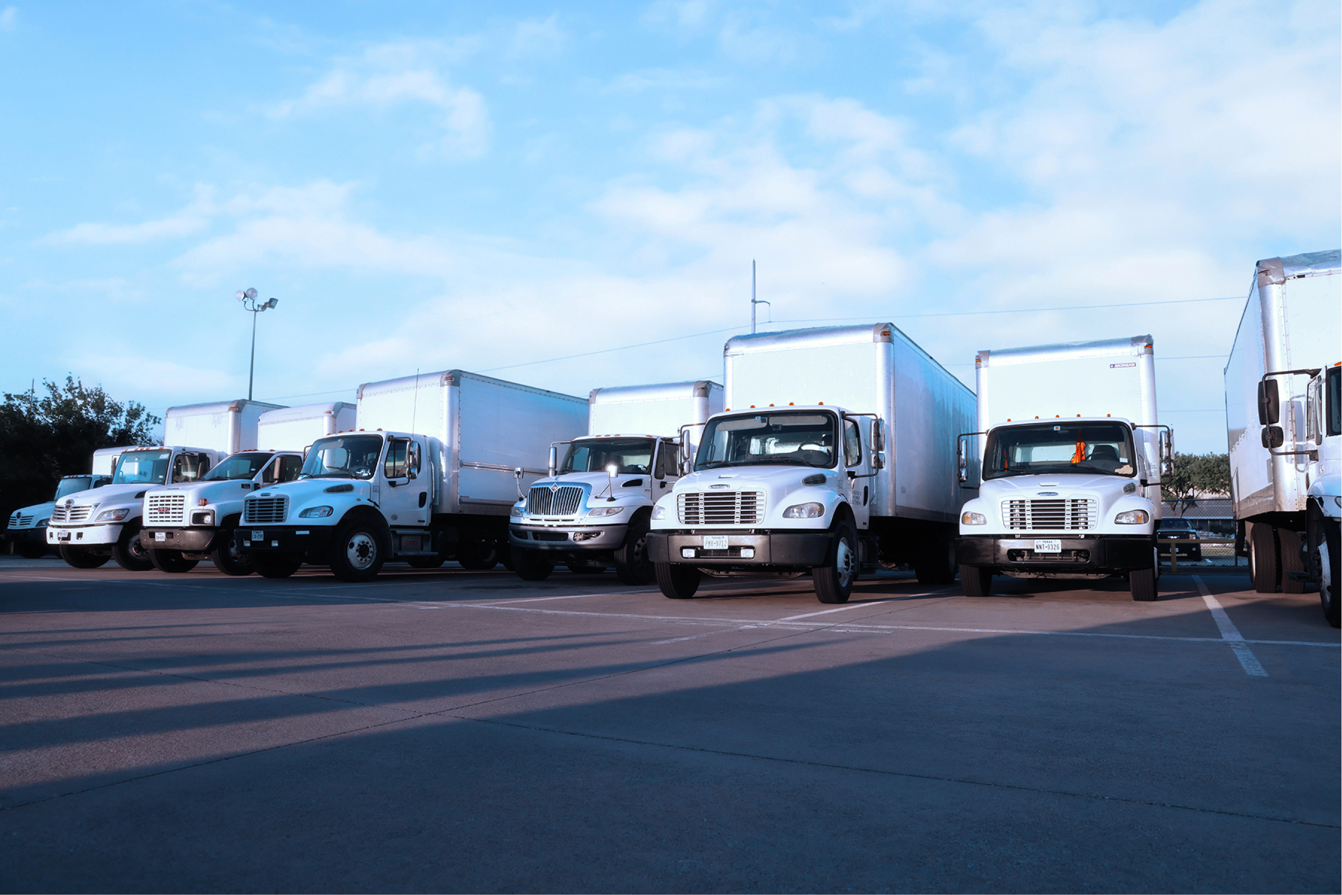 white fleet trucks parked at the truck station waiting for mobile fleet maintenance